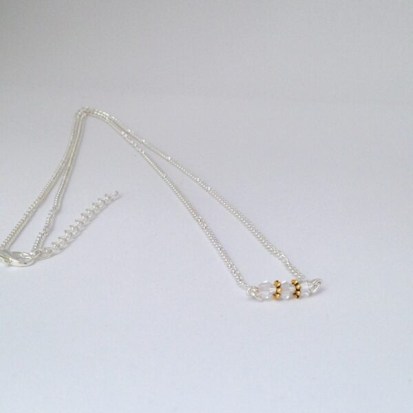 Collier toupies transparentes et or