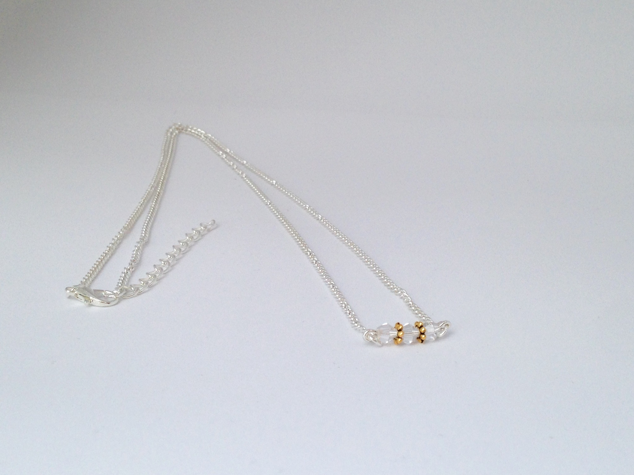 Collier toupies transparentes et or