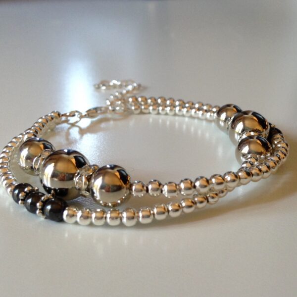 Bracelet double avec perles miroir et entretoises garnies de mini brillants